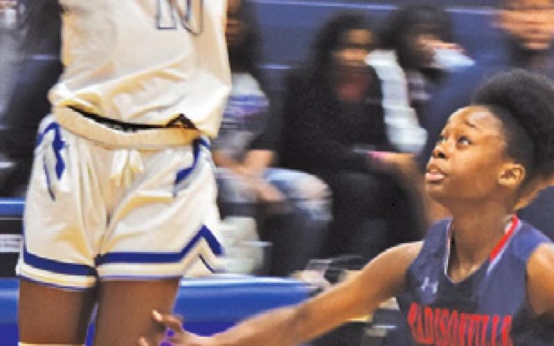 BRE’ASIA LOUIS jumps to catch a pass during Snook’s loss to Madisonville last Tuesday.