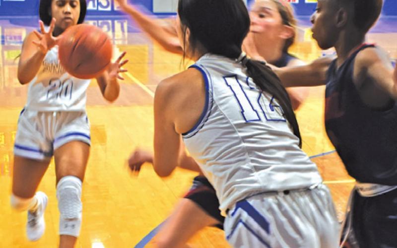 SNOOK’S ALANA STRINGFELLOW catches a pass from teammate Carmen Miller during the Lady Jays’ loss to Madisonville last week.