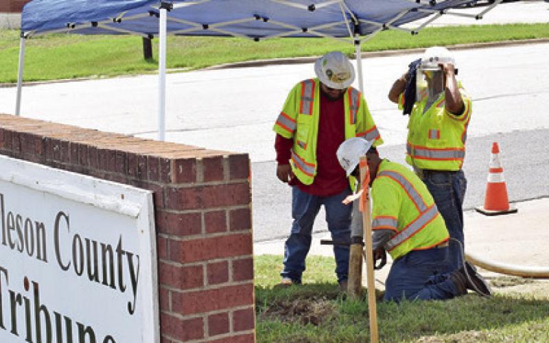A CREW FROM LARRETT Energy Services of Venus works at the Burleson County Tribune off State Highway 21 West and Thomas Street in preparation for Atmos work beginning next week.