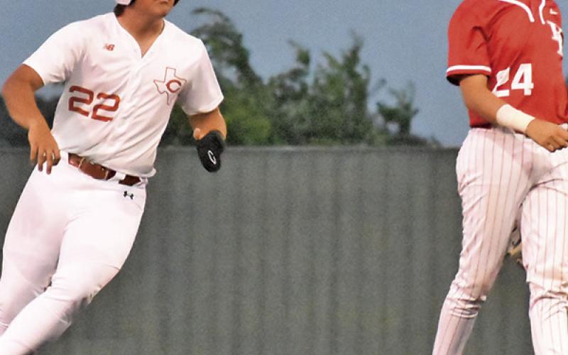 CALDWELL’S CASON RUSS runs to second base against Bellville. Tribune photo by Roy Sanders