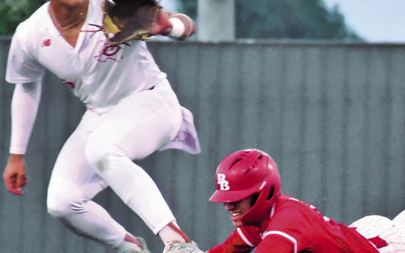 COY BECKA GETS ready to catch the ball as this Bellville player slides into second base in last Friday’s game. Tribune photo by Roy Sanders