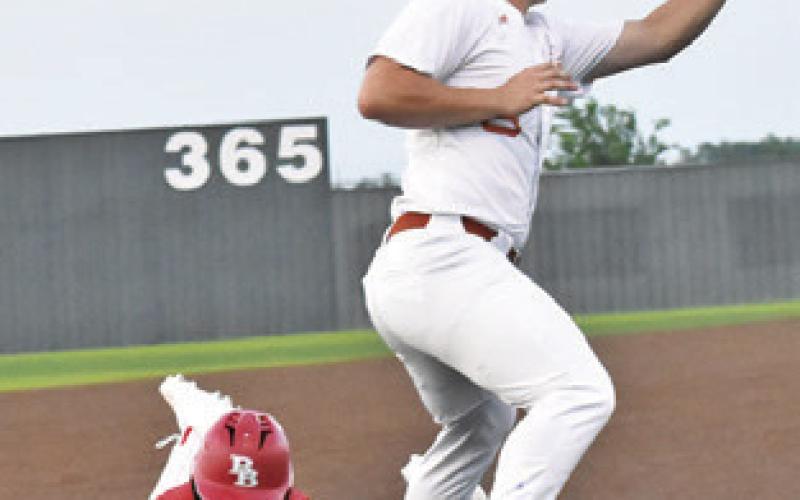 CALDWELL THIRD baseman Kaleb Dodson makes a catch as a Bellville player slides. Tribune photo by Roy Sanders
