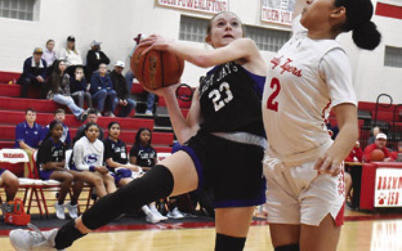 SNOOK’S DAKOTA KIENOW tries to shoot and avoid a foul during the Lady Jays’ away game in Bremond on Friday night. Tribune photo by Roy Sanders