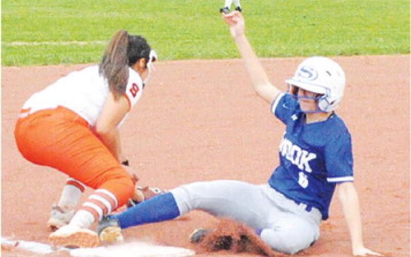 SNOOK’S TAYLOR GROCE slides safely into third base during the Snook-Somerville game last Friday night. -- Tribune photo by Denise Squier