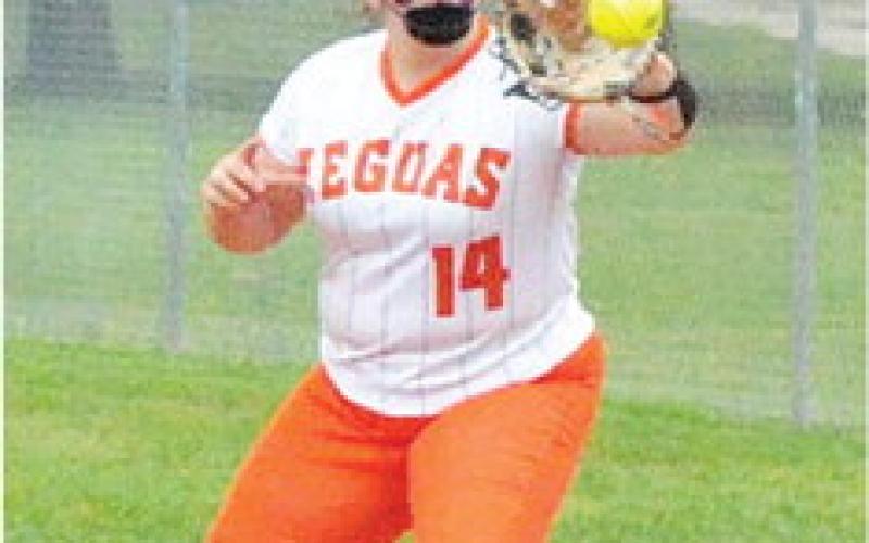 AUBREY KOVASOVIC grabs the throw to first for a force out during the Snook-Somerville game last Friday. -- Tribune photo by Denise Squier