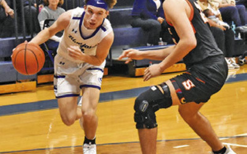 BRETT WITHEM of Snook dribbles past Somerville’s Gavin Williams. Tribune photo by Roy Sanders