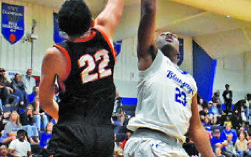 KETREEN CARTER of Snook shoots as Gavin Williams of Somerville moves in. Tribune photo by Roy Sanders