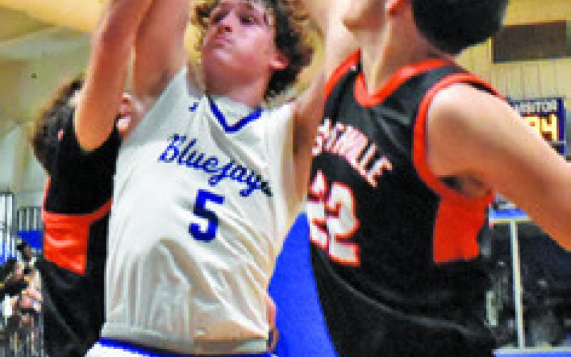 BRAYDEN MACIK of Snook tries this shot as Gavin Williams of Somerville defends. Tribune photo by Roy Sanders