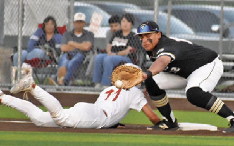 HAYS BEAVERS OF Caldwell slides back into first base. Tribune photo by Roy Sanders