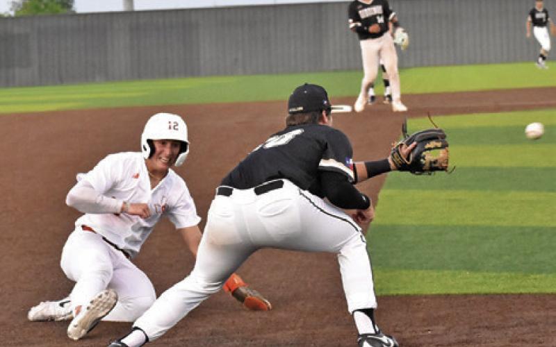 COY BECKA OF Caldwell slides into third base safe against Giddings. Tribune photo by Roy Sanders