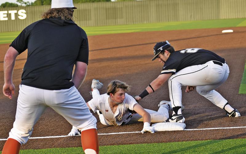 RYAN SEE SLIDES into third base last Friday against Giddings. Tribune photo by Roy Sanders