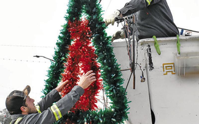 CITY OF CALDWELL employees take down the Christmas decorations on Monday, Jan. 5, in downtown Caldwell. Tribune photo by Roy Sanders