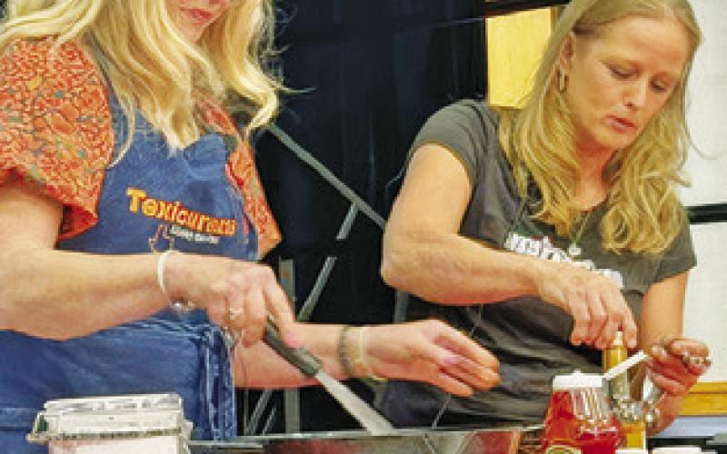 CINDY WILLIAMS, “Texicurean” -- inspired by her passion for Texas food and hospitality, and Shelly Spivey make Sam Houston’s barbecue sauce. Williams held a cooking presentation last Tuesday night in honor of the county’s annual Heritage Week.