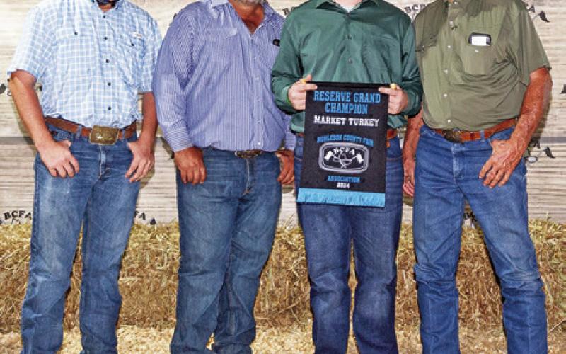 THE RESERVE GRAND Champion Market Turkey winner was Brycen Suehs. Also pictured are Cameron Suehs, Bradley Suehs and Tommy Tietjen. Photo courtesy of Jeffries Livestock Marketing