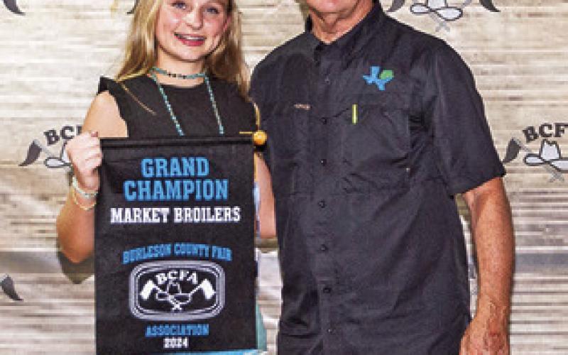 THE GRAND CHAMPION in Market Broilers was exhibited by Kanzie Mantey. She is pictured with Ben Flencher. Photo courtesy of Jeffries Livestock Marketing