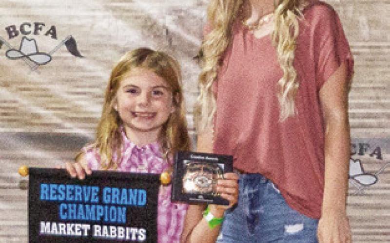 THE RESERVE Grand Champion winner in Market Rabbits is Brooklyn Hafernick. She is pictured with Macy Carlson. Photo courtesy of Jeffries Livestock Marketing