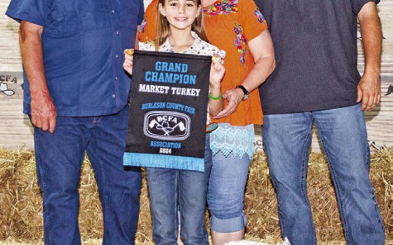 THEGRANDCHAMPION in Market Turkeys, Hallie Muzny is pictured with Charlie, Julie and Colton Eubanks.