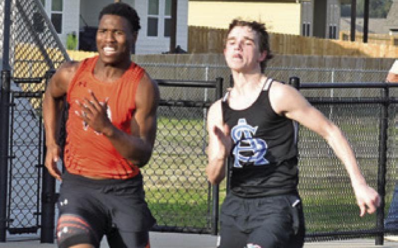 JA’KEITH DANIELS (left) runs during the Bluejay Relays in Snook last Thursday. Tribune photo by Roy Sanders