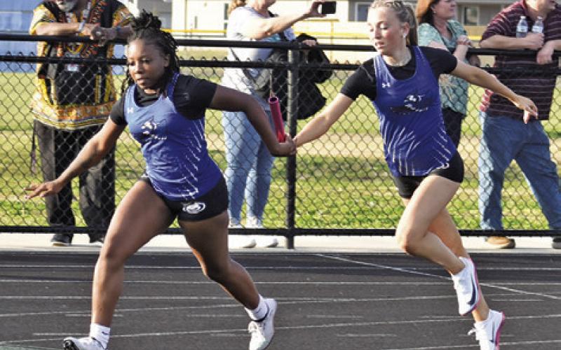 SNOOK’S BRAYNIJA POOL receives the baton hand-off from Kennedi Withem during last Thursday’s Bluejay Relays in Snook. Tribune photo by Roy Sanders