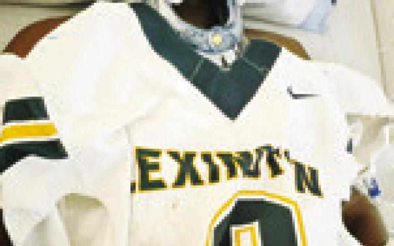JURIAN MOORE holds his jersey while hospitalized after the injury.