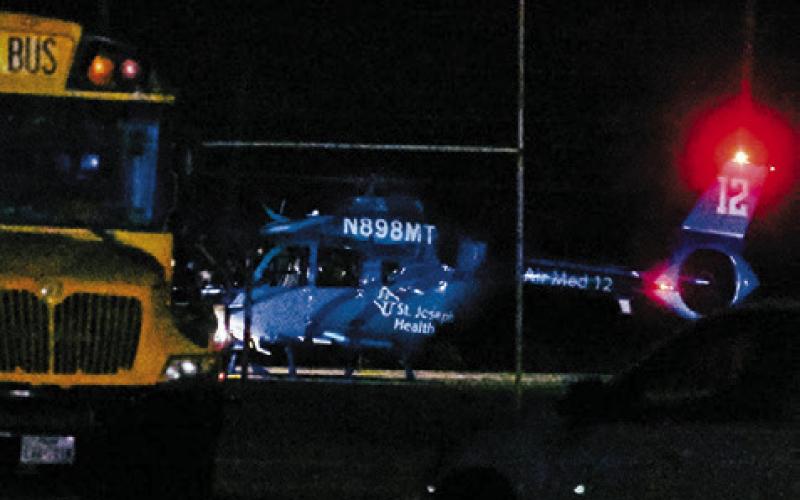 A HELICOPTER LANDS to transport Jurian Moore to the hospital.