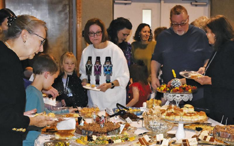 VISITORS GET A plate of food last Saturday at the Angel Tea at First United Methodist Church in Somerville.