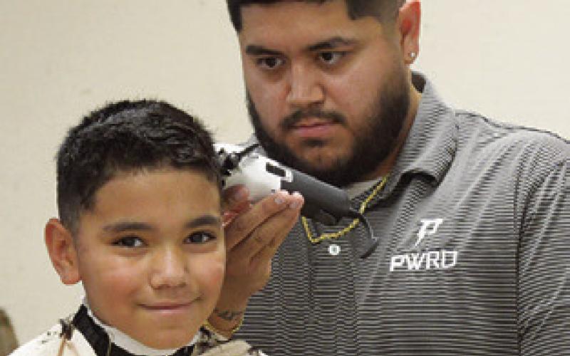 SCHOOL SUPPLIES were not the only things given away at last Wednesday’s “Back to School Blast.” People also received haircuts, diapers and other items for free. Tribune photo by Denise Squier