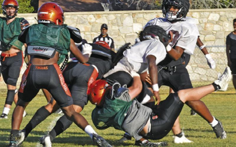 SOMERVILLE’S PETER SALAZAR makes a tackle as teammate Semaj Pennygraph moves in to help. -- Tribune photo by Roy Sanders