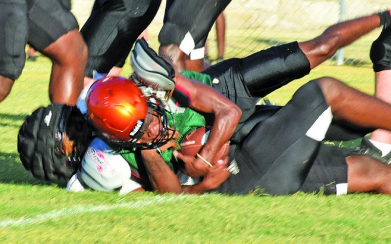 HERSCHEL CONWAY MAKES a tackle against Hearne in the Friday scrimmage at Yegua Stadium. -- Tribune photo by Roy Sanders