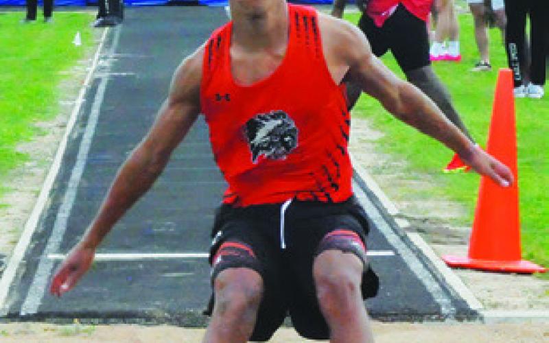 JA’ILLE DEERE lands after jumping during the varsity boys long jump at last week’s District 26-2A Track Meet in Snook. Tribune photo by Denise Squier