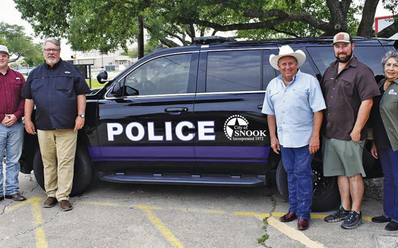 CLIFFORD DORN, fourth from the right, joins the Snook City Council in looking over this police vehicle. The council members include, from left, John Pollock, Bradan Harris, Mayor Frank Fields, Matt Collins, Tina Vega and Wade Elkins.