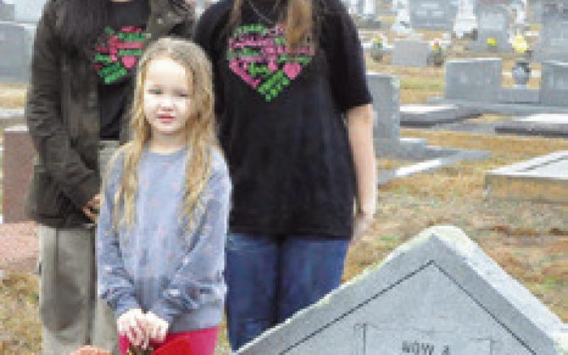 SNOOK RESIDENTS of all ages participated in “Wreaths Across America,” placing swags on veterans’ graves in the Snook Cemetery. Tribune photo by Denise Squier
