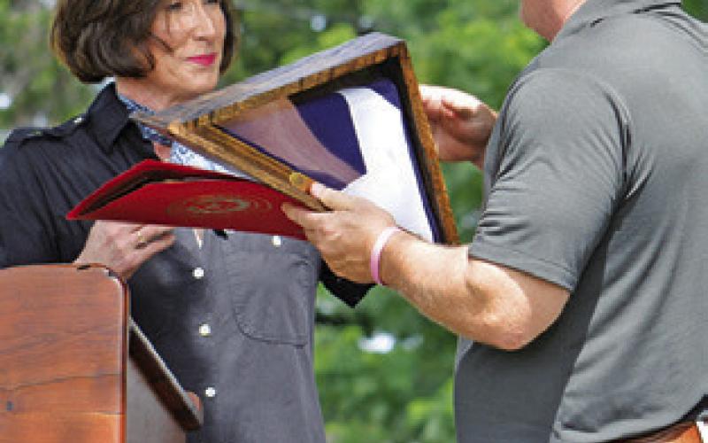 STATE SEN. LOIS Kolkhorst presents this flag to Aaron Flencher of Citizens State Bank.