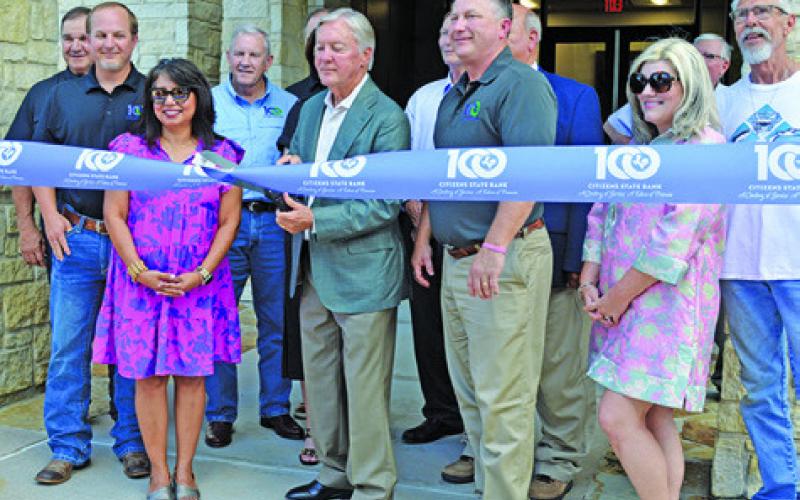 CITIZENS STATE BANK officials cut the ribbon to formally dedicate their new lobby at the Friday, June 6, 100th anniversary celebration.