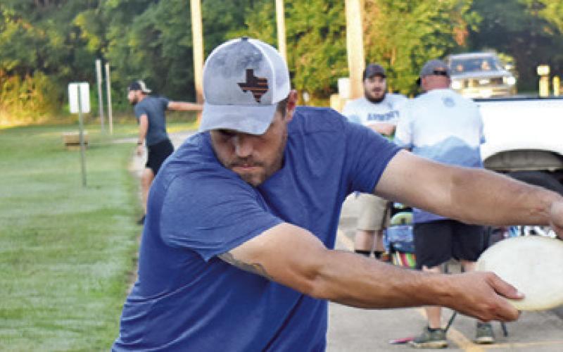 A DISC GOLFER warms up on Saturday at the grand opening tournament for Caldwell’s Disc Golf Course at John E. Hejl Park at Davidson Creek. More than 50 disc golfers played in the tournament.