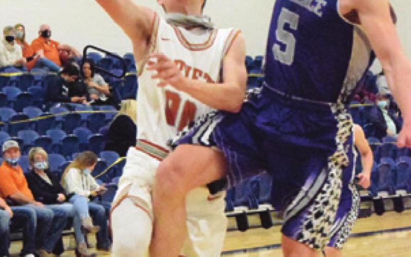 CALDWELL’S LANCE LARA is fouled by a Florence player during Caldwell’s 77-25 win last Friday. -- Tribune photo by Denise Squier