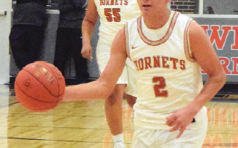 ZACK HEATON dribbles the ball down the court during the Caldwell-Florence game last Friday. -- Tribune photo by Denise Squier