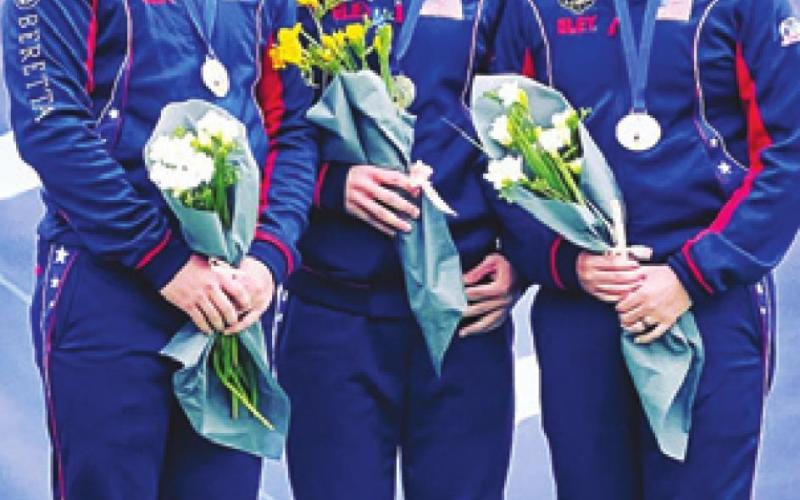 PHILLIP JUNGMAN, left, stands with his teammates, Colt McBee and Hayden Stewart, as they receive their silver medals from competing in the Men’s Skeet Team competition at the World Cup in Cypress last week.