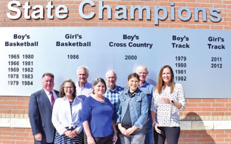 SNOOK RECOGNIZES ITS state champions with this sign. Pictured are, front row, from left, Dana Yezak, Snook Superintendent Brenda Krchnak, and Megan Simank; back row, Donnie Victorick, Jimmy Horn, Don Horn and Melvin Schoeneman.