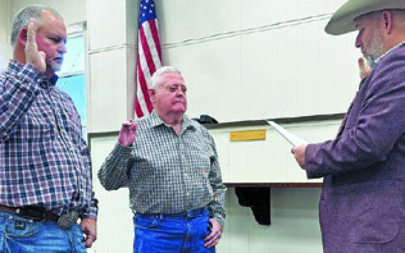 BURLESON COUNTY COMMISSIONERS Dwayne Faust and David Hildebrand are sworn in on Jan. 1 by County Judge Keith Schroeder.