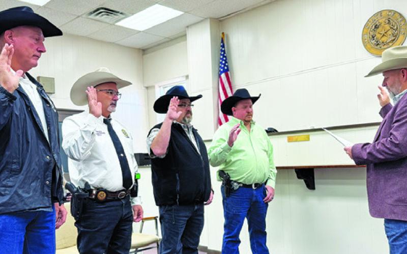 BURLESON COUNTY CONSTABLES are sworn into office on Jan. 1 by County Judge Keith Schroeder. They include, from left, Dennis Gaas, Jay Boykin, Jason Rhodes and Jason Muzny.