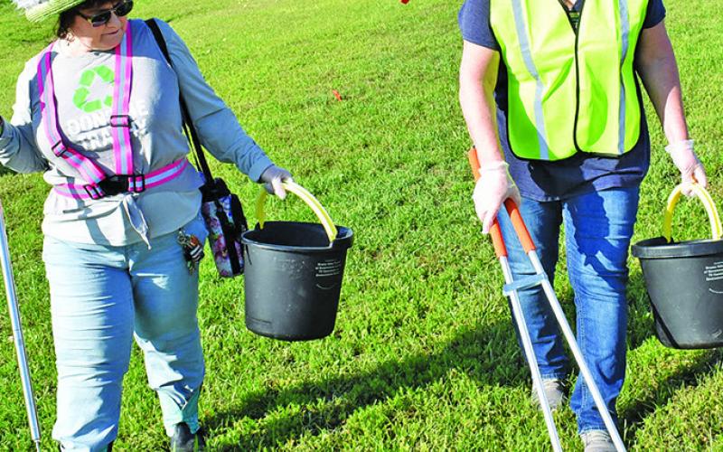 KATHY POLLOCK AND Raileen Murray pick up debris on Saturday morning, April 12, as part of the Keep Burleson County Beautiful Spring Clean Trash Off on State Highway 21 East in Caldwell.