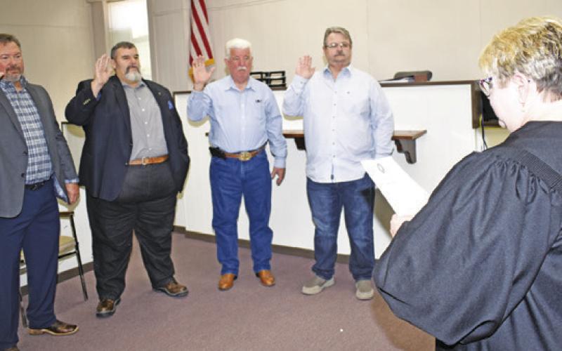 BURLESON COUNTY JUSTICES OF the Peace are sworn into office by District Judge Reva Towslee Corbett. They include, from left, Dusty Tittle, Precinct 1, Jason Urbanosky, Precinct 4, Bill Orsak, Precinct 2, and Johnny Towslee, Precinct 3.