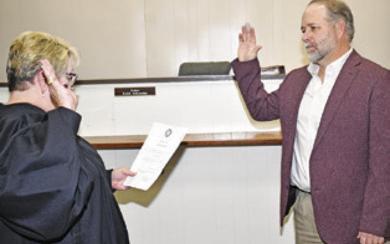 BURLESON COUNTY JUDGE Keith Schroeder is sworn into office by District Judge Reva Towslee Corbett. -- Tribune photo by Roy Sanders