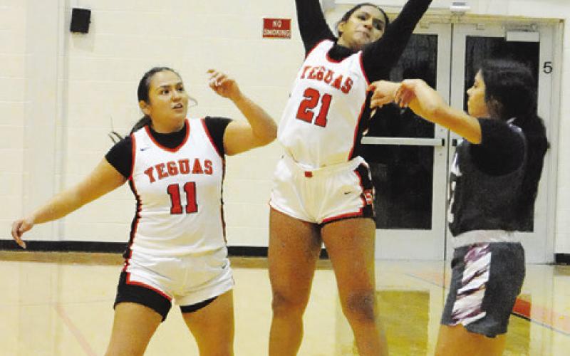 SOMERVILLE’S EMMA WILLIAMS jumps to attempt to block an Iola pass during the Somerville-Iola game last week. Also pictured is Viviana Munoz. -- Tribune photo by Denise Squier