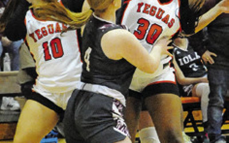 KEIRA MOORE looks to pass the ball over an Iola defender during the Somerville-Iola game last Wednesday night in Somerville.