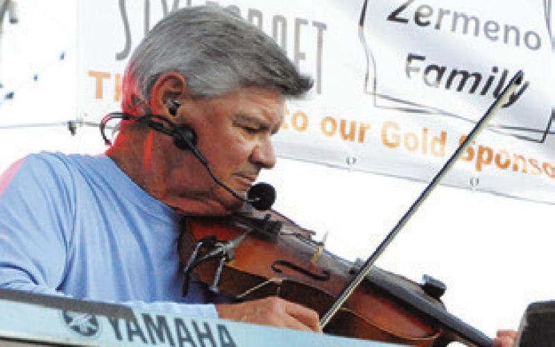 FIDDLES AND keyboards were featured during the Summer Concert Series performance by Texas Unlimited Band (TUB).