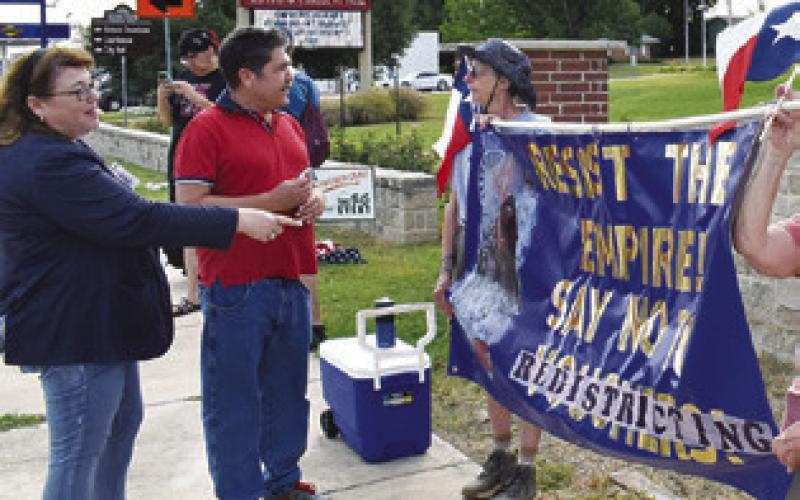 U.S. CONGRESSIONAL CANDIDATE Dawn Marshall, left, talks to the protesters on Saturday in front of the Caldwell Civic Center.