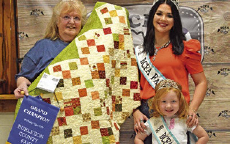 TWANA BENNER WON GRAND in Adult Quilts. Also pictured are Fair Queen Kodi Hitchcock and Little Miss Taytum Hohlt. Tribune photo by Sabine Lazo