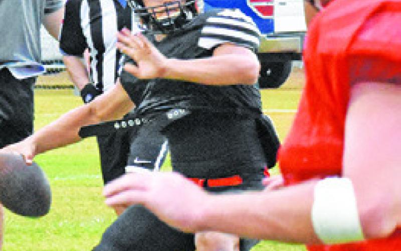 IAN TEAGUE of Somerville hurls this pass against the Rosehill Christian Schooldefense.